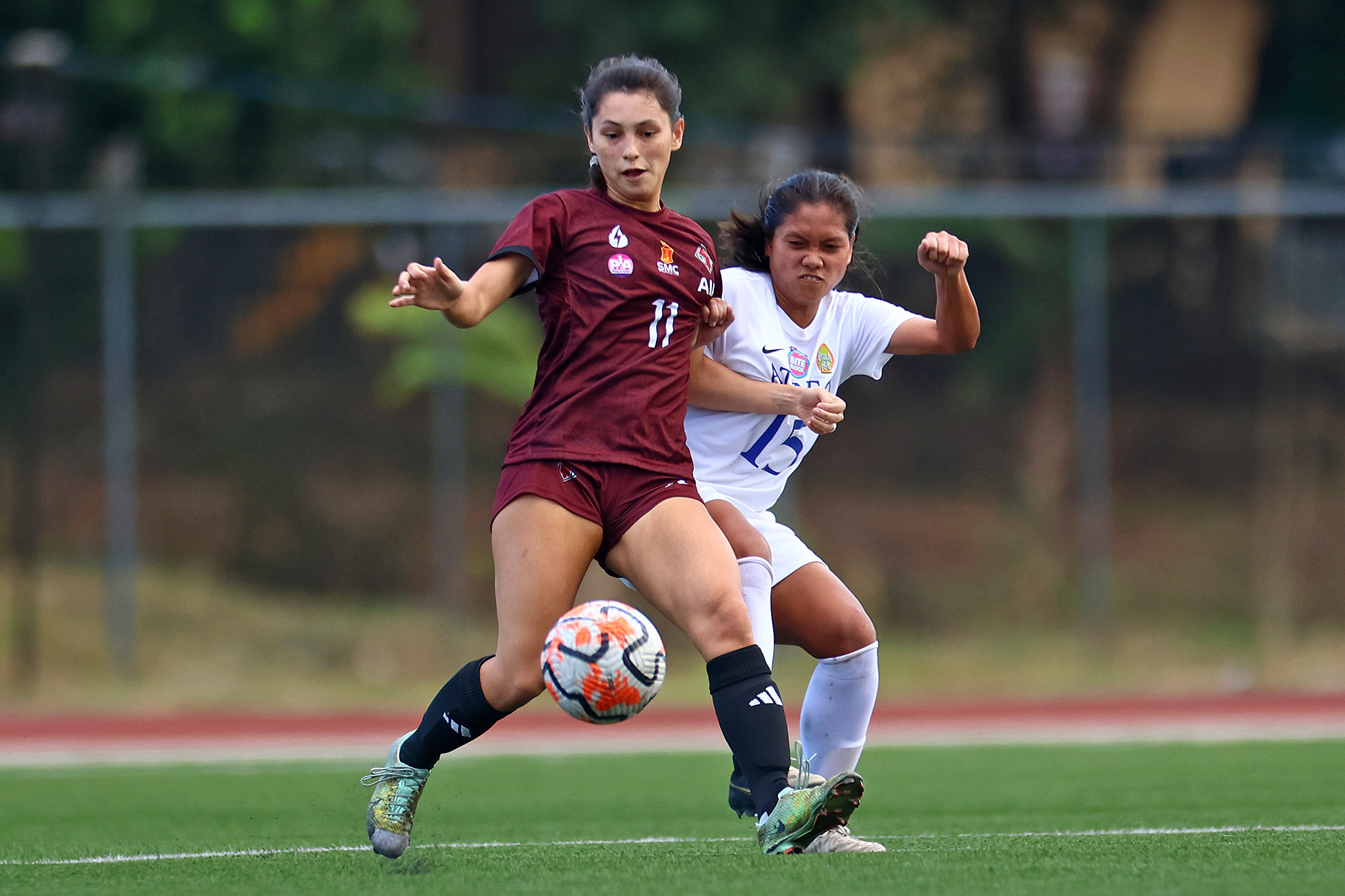 Jennifer Baroin (UP) and Angely Alferez (Ateneo) fight for the ball in the UAAP S86 Women's Football game