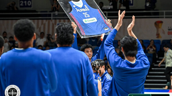 Japeth Aguilar lifts a framed jersey at a retirement tribute with Gilas Pilipinas ahead of their game against Guam, at the Blue Eagle Gym